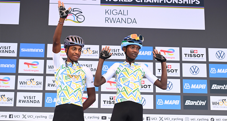 Moïse Ntirenganya and Jackson Nkurikiyinka greeting the Rwandan crowd during the sign-on before the Men Junior Road Race in Kigali
